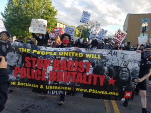 Party for Socialism and Liberation PSL members march in Boston. The banner they hold reads "The people united will stop racist police brutality."