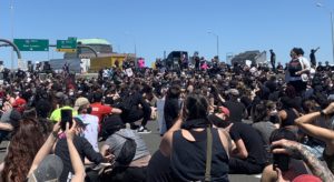Peaceful protestors shut down a highway in Connecticut, Sunday May 31. They sit on the pavement. 